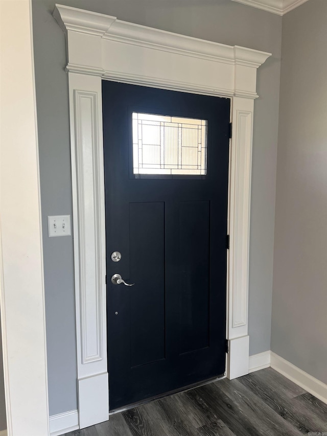 foyer entrance featuring dark hardwood / wood-style floors and crown molding