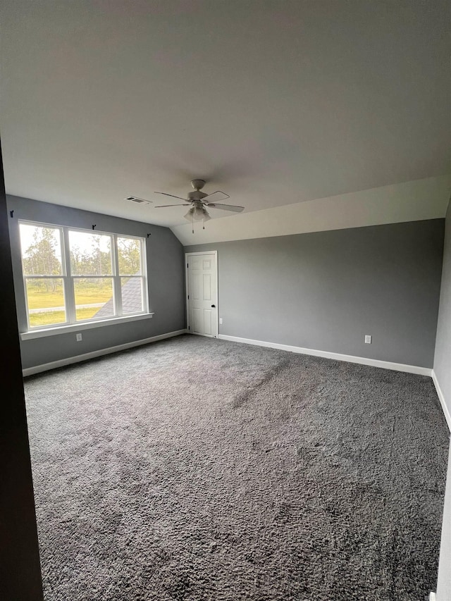 spare room featuring ceiling fan, carpet flooring, and lofted ceiling