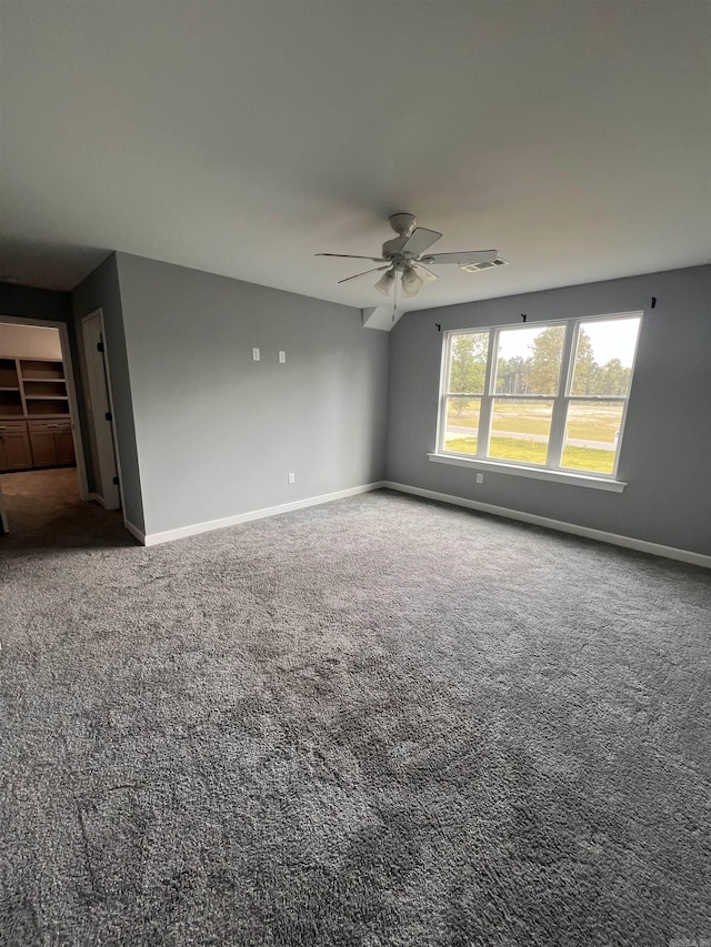 spare room featuring ceiling fan and carpet