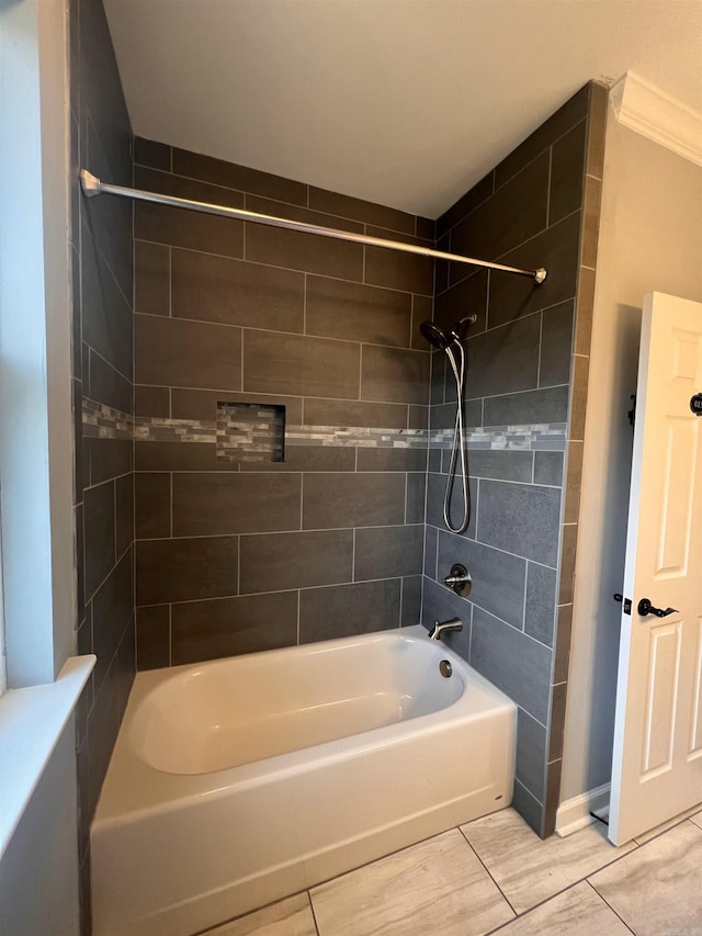 bathroom featuring tile patterned flooring and tiled shower / bath combo