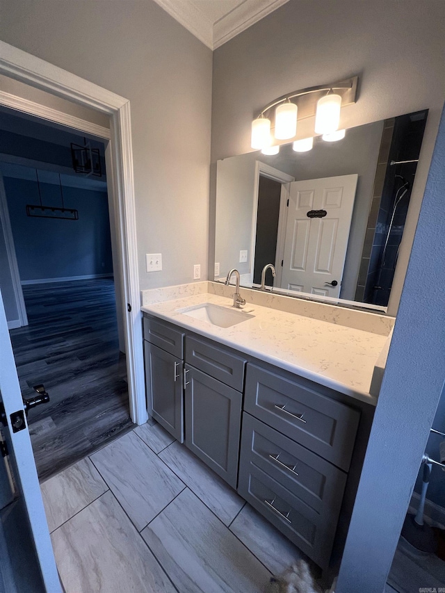 bathroom featuring vanity, hardwood / wood-style floors, and ornamental molding