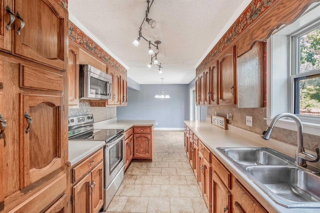 kitchen with light tile patterned floors, backsplash, stainless steel appliances, and a textured ceiling