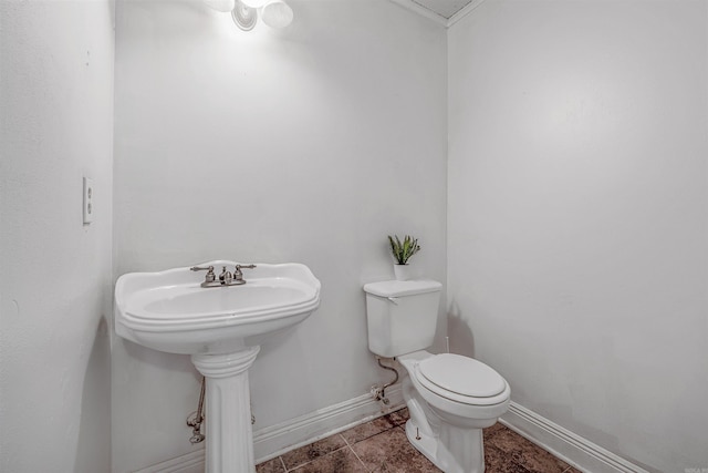 bathroom with toilet and tile patterned floors