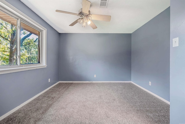 spare room featuring ceiling fan and carpet flooring