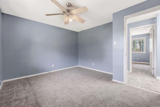 spare room with carpet floors and ceiling fan