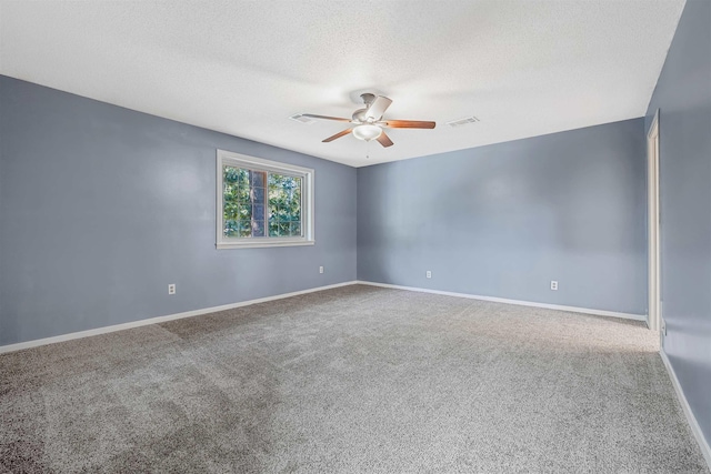 unfurnished room with ceiling fan, carpet, and a textured ceiling