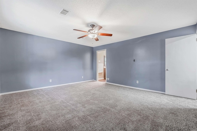 unfurnished room with ceiling fan, a textured ceiling, and carpet flooring