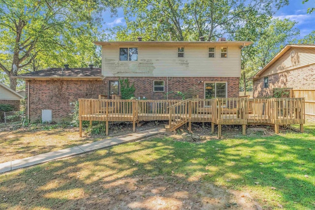 back of house featuring a yard and a wooden deck