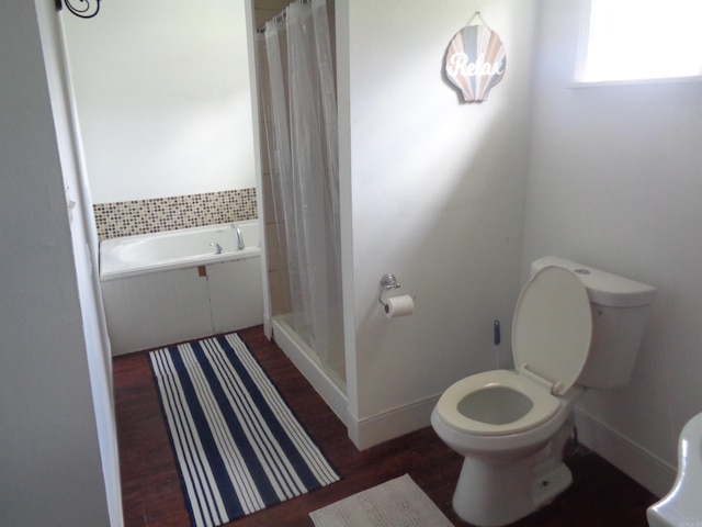 bathroom featuring separate shower and tub and toilet