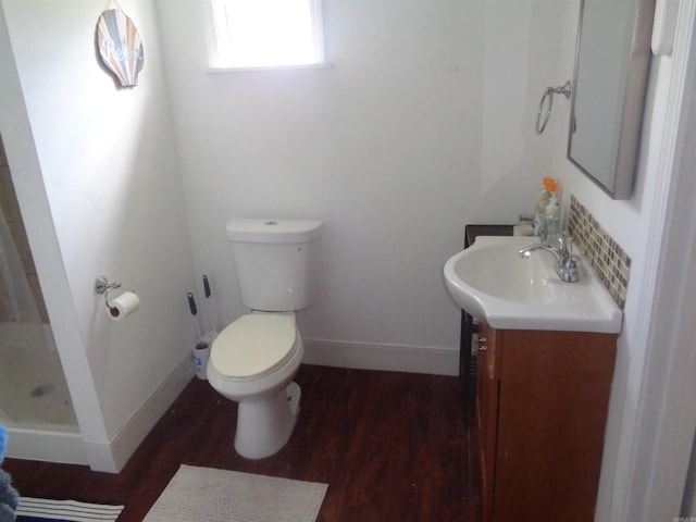 bathroom with toilet, hardwood / wood-style floors, a shower, and vanity