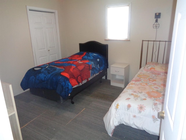 bedroom with a closet and dark hardwood / wood-style flooring