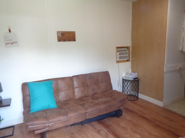 living room with wood-type flooring and a wall mounted AC