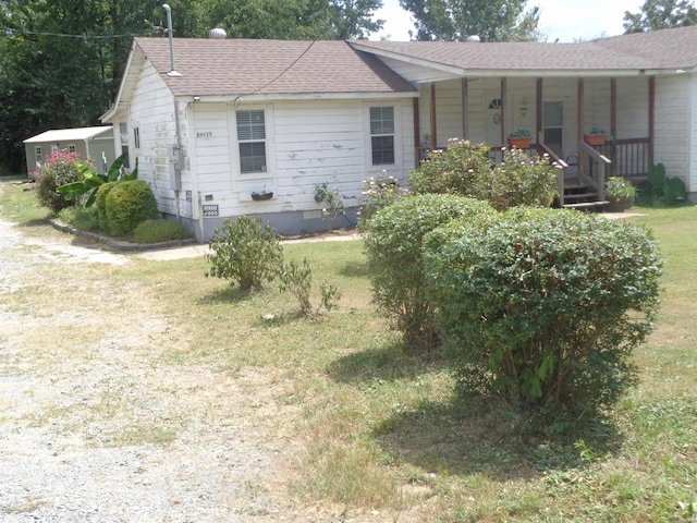 ranch-style house with a porch, a front yard, crawl space, and a shingled roof