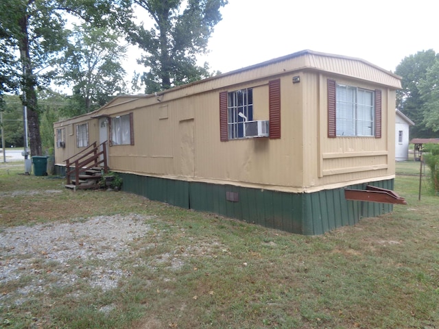 view of home's exterior with a yard and cooling unit