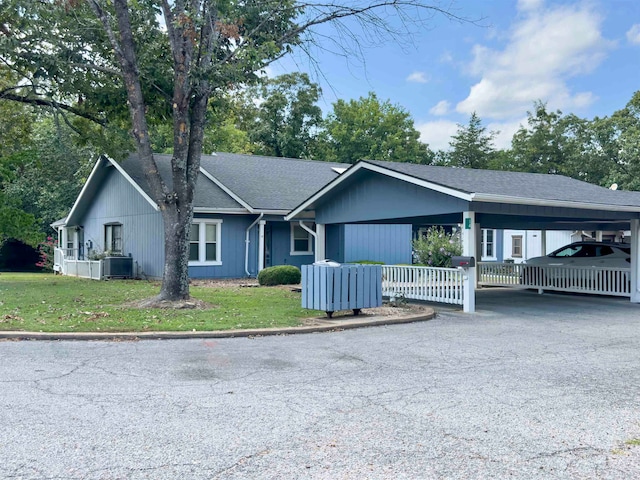 single story home with a carport and a front yard