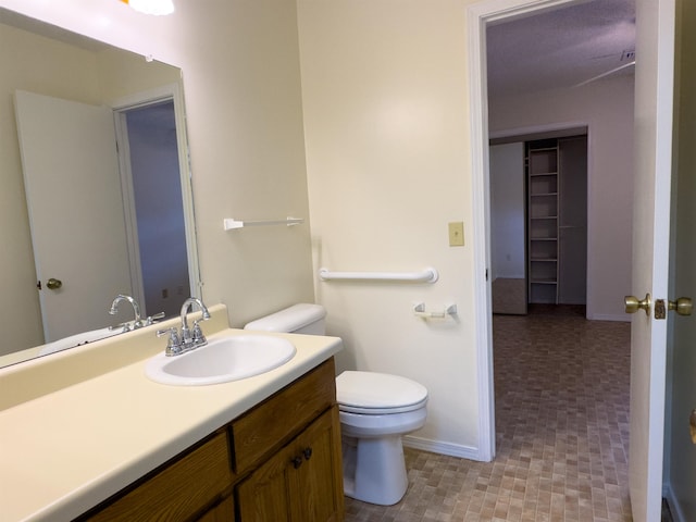 bathroom with tile patterned flooring, vanity, and toilet