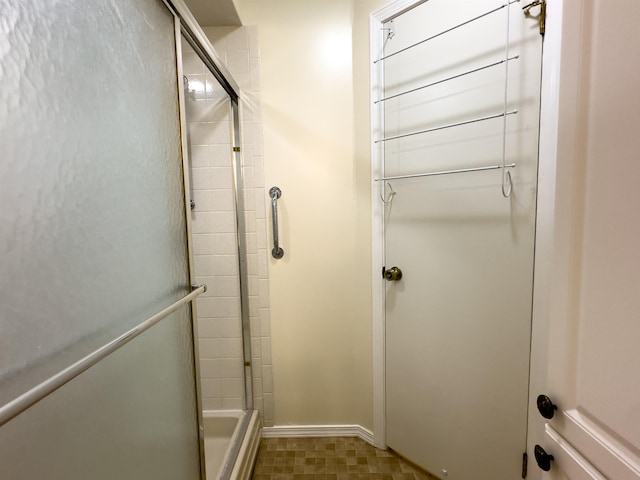 bathroom with tile patterned flooring and an enclosed shower