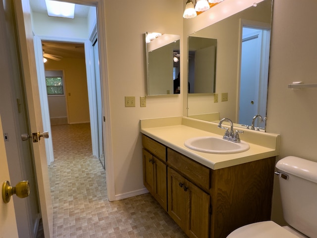 bathroom featuring tile patterned flooring, ceiling fan, toilet, and vanity