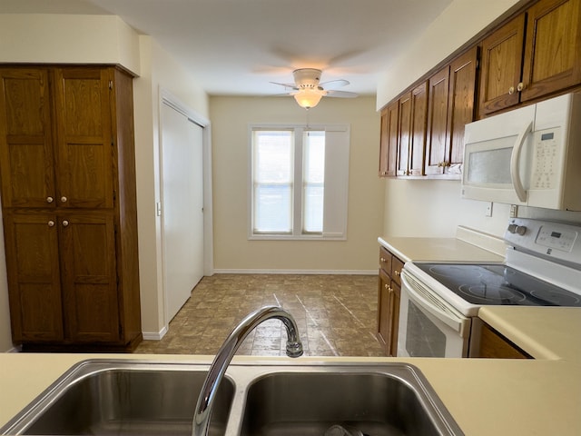 kitchen with ceiling fan, sink, white appliances, and light tile patterned floors