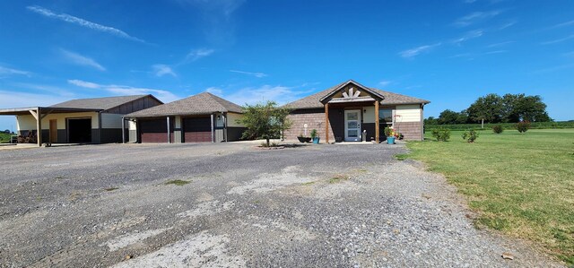 view of front of home with a front lawn and a garage