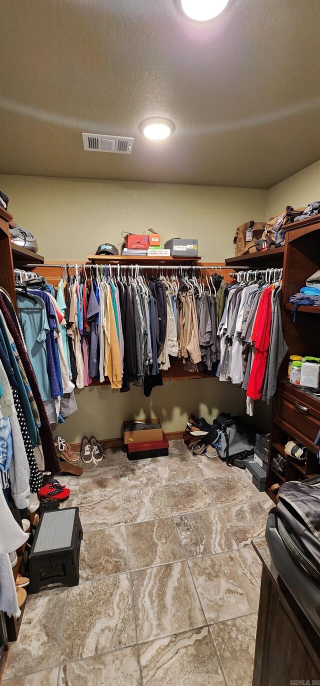 walk in closet with tile patterned floors