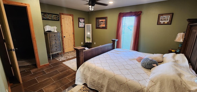 tiled bedroom featuring ceiling fan