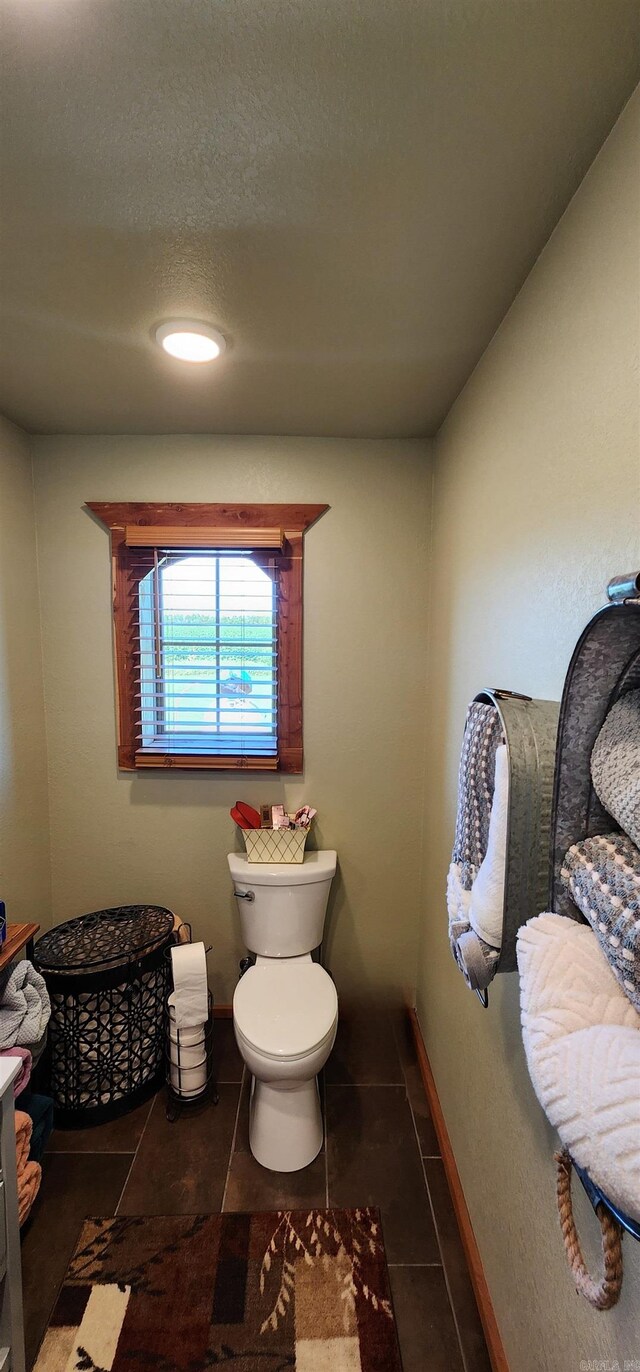 bathroom with tile patterned floors, a textured ceiling, vanity, and toilet