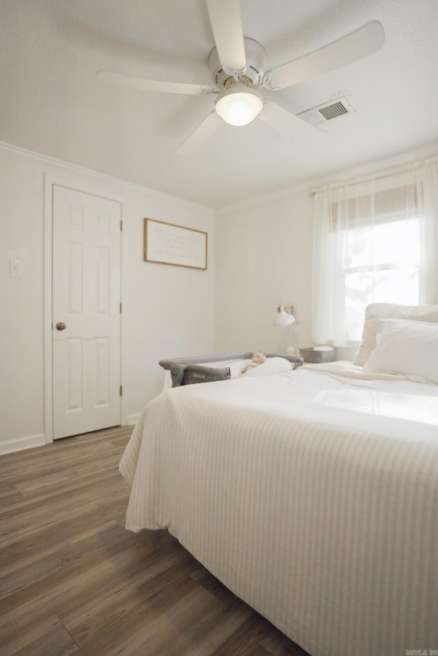 bedroom with ceiling fan and wood-type flooring