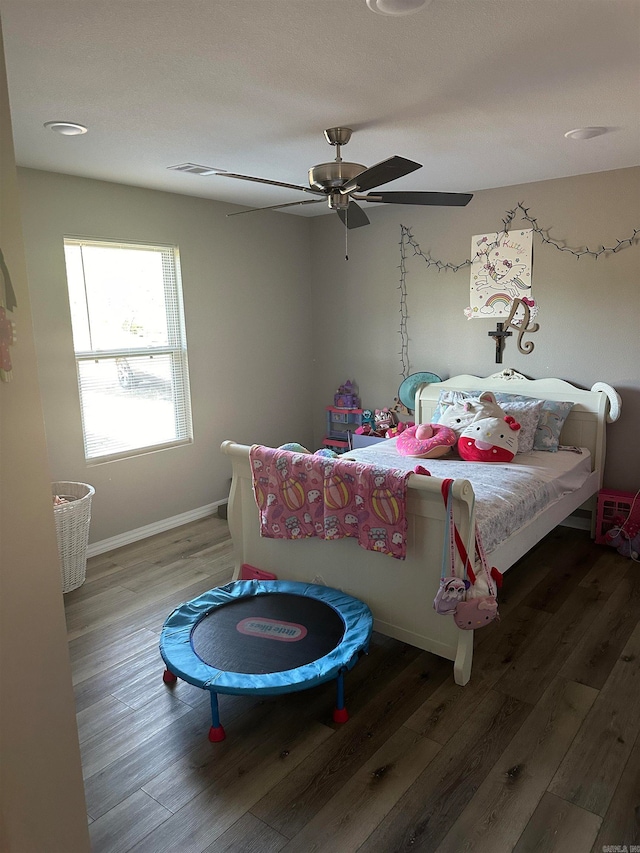 bedroom with ceiling fan and hardwood / wood-style flooring