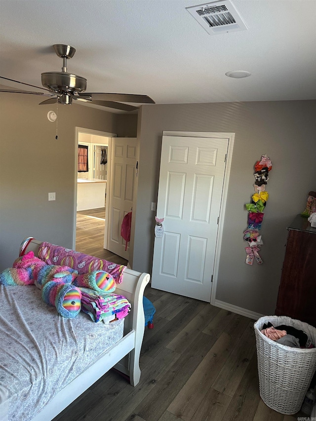 bedroom featuring ceiling fan and dark hardwood / wood-style floors