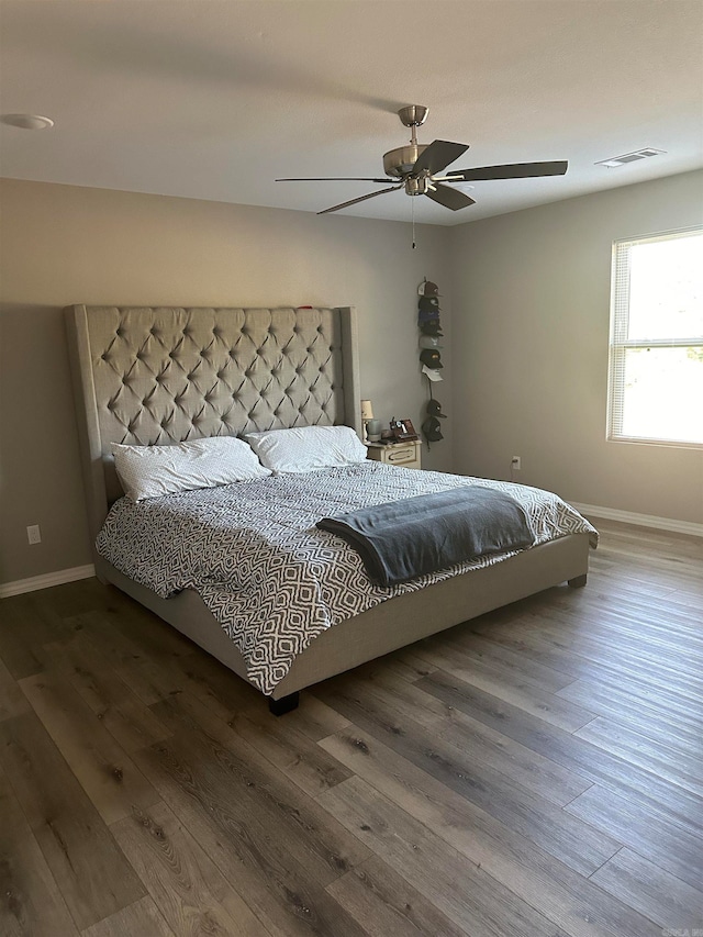 bedroom with ceiling fan and hardwood / wood-style flooring