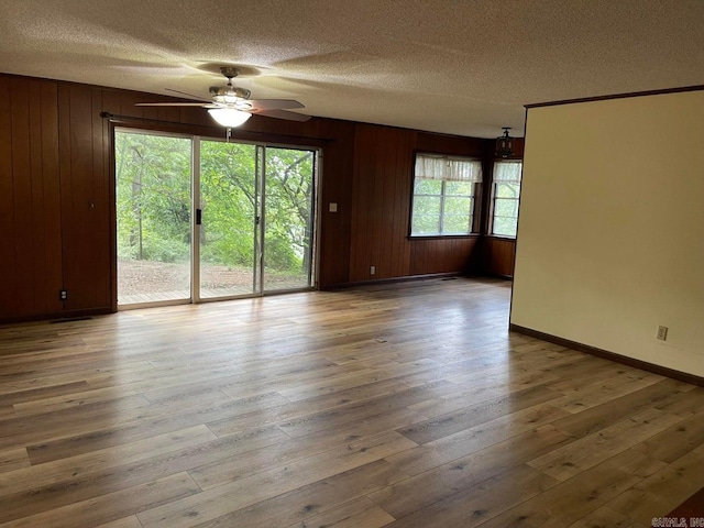 spare room featuring ceiling fan, a textured ceiling, and hardwood / wood-style floors