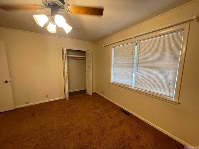 unfurnished bedroom featuring carpet flooring, ceiling fan, and a closet