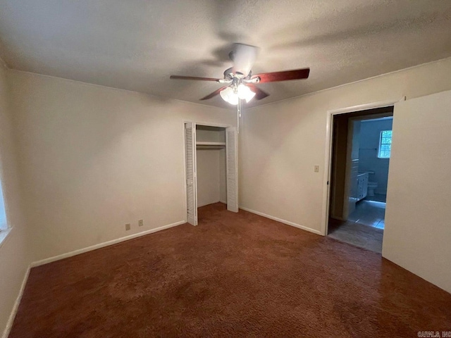 interior space featuring a textured ceiling, carpet flooring, ceiling fan, and a closet