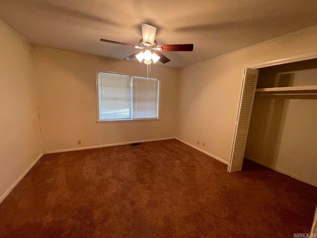 unfurnished bedroom featuring ceiling fan, carpet flooring, and a closet