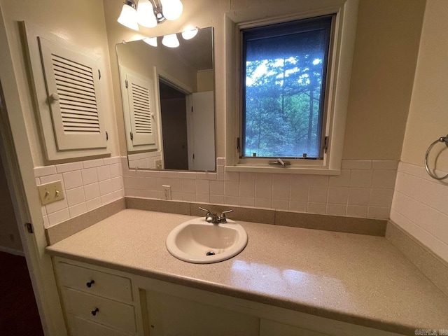 bathroom with decorative backsplash and vanity