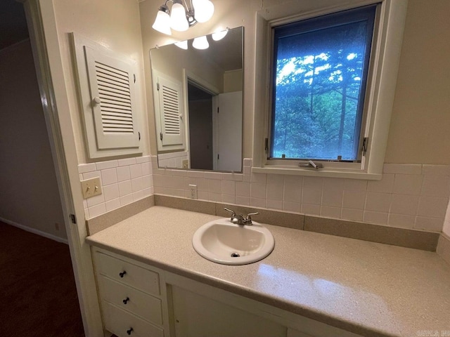 bathroom with backsplash, a chandelier, and vanity