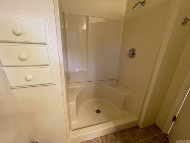 bathroom featuring a shower and tile patterned flooring