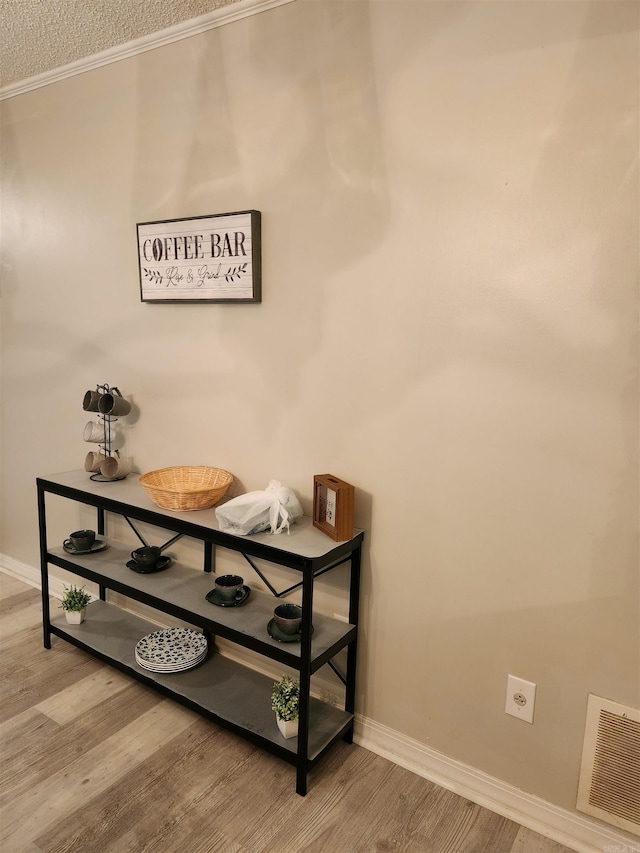 room details with visible vents, baseboards, and wood finished floors