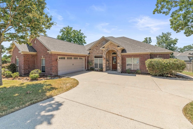 view of front of house with a garage and a front yard