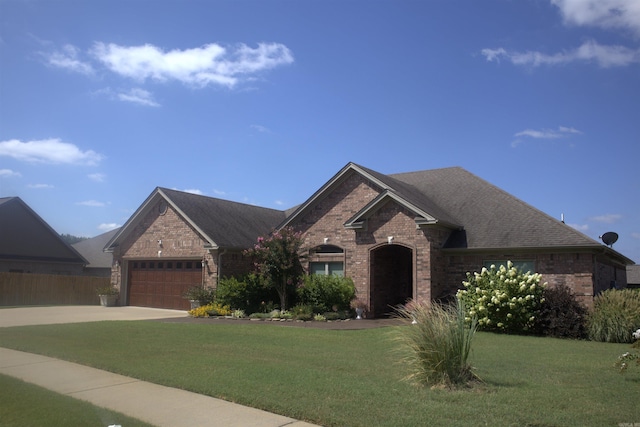 view of front of house featuring a garage and a front yard