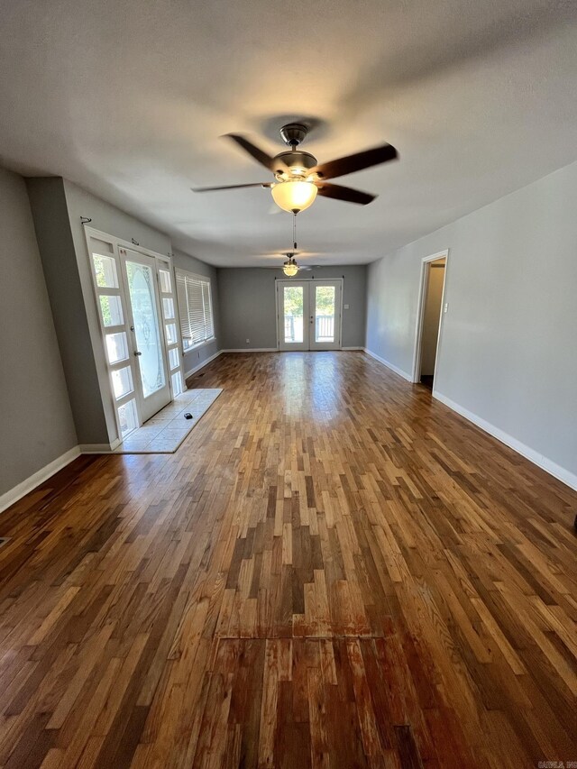 unfurnished room featuring ceiling fan, french doors, and wood-type flooring