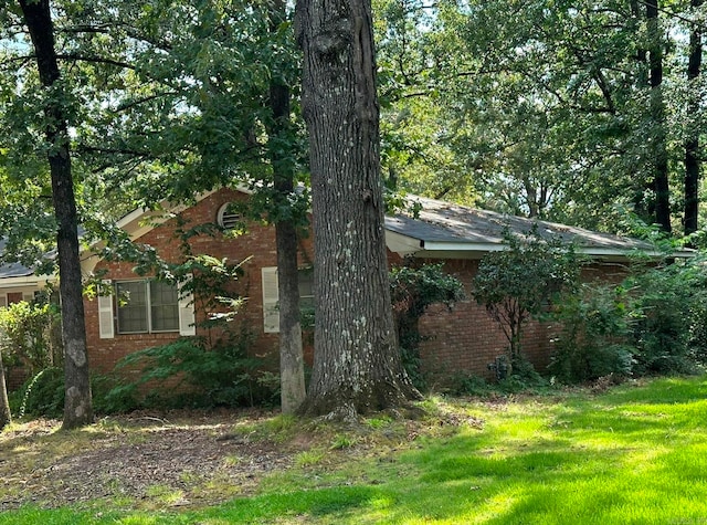 view of side of property with a yard