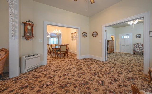 hallway featuring heating unit, carpet floors, and a chandelier