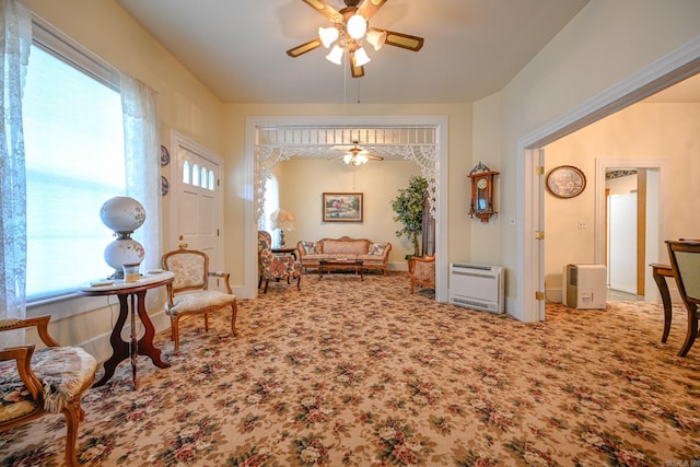 living area featuring carpet and ceiling fan