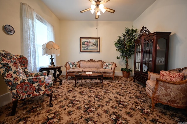 carpeted living room with ceiling fan