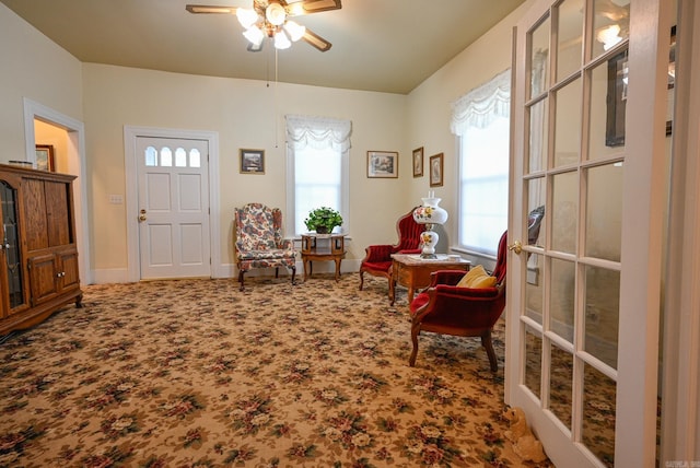 sitting room with ceiling fan and carpet floors