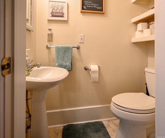 bathroom with tile patterned flooring and toilet