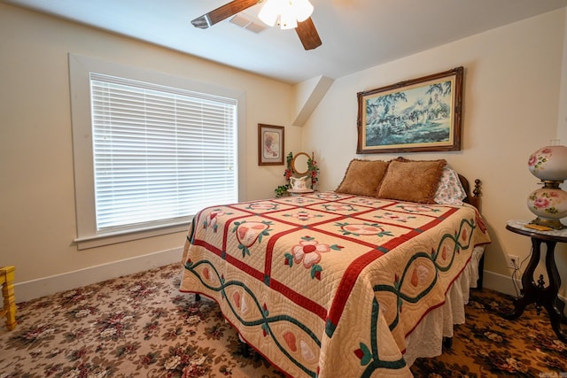 carpeted bedroom featuring ceiling fan and multiple windows