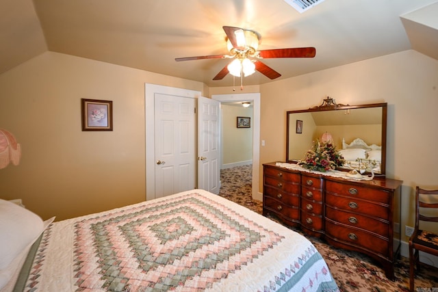 bedroom with dark colored carpet, ceiling fan, and lofted ceiling